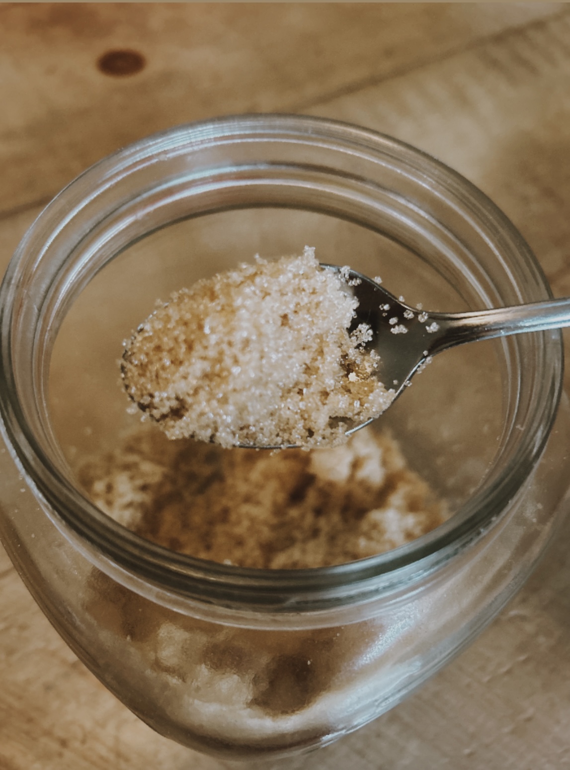 glass jar with a scoop of brown sugar