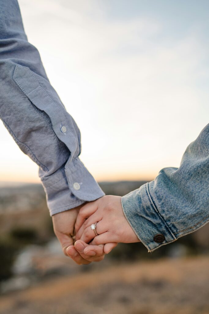 husband and wife holding hands in light